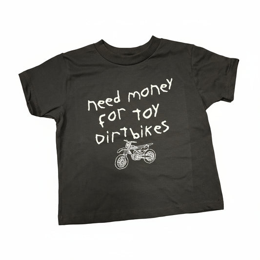 Black Toddler Tshirt with white handwritten font that says "Need Money for Toy Dirtbikes" with a sketchy dirtbike drawing